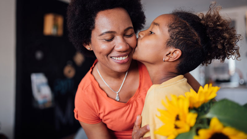 Mother and son saying thank you with flowers.