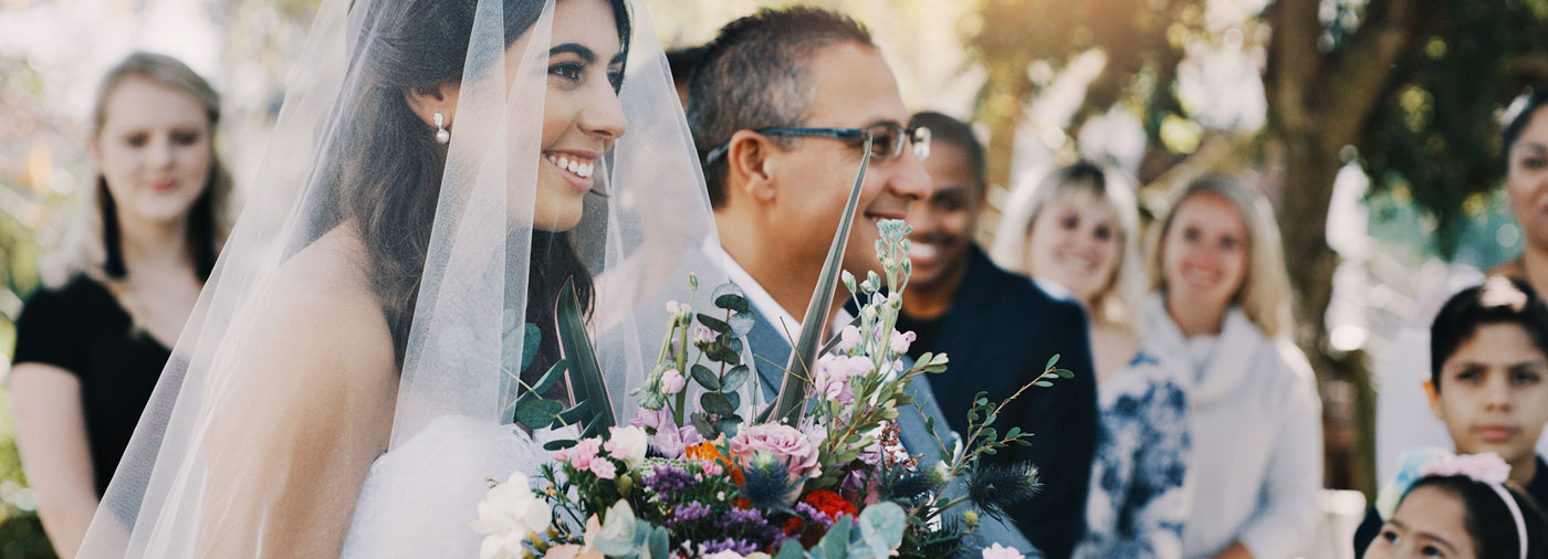 women holding wedding flowers